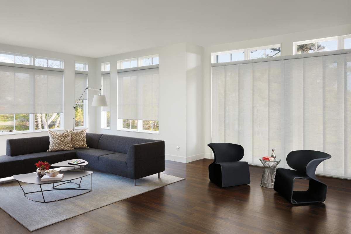 A sitting area featuring soft light falling over a blue couch and round coffee table