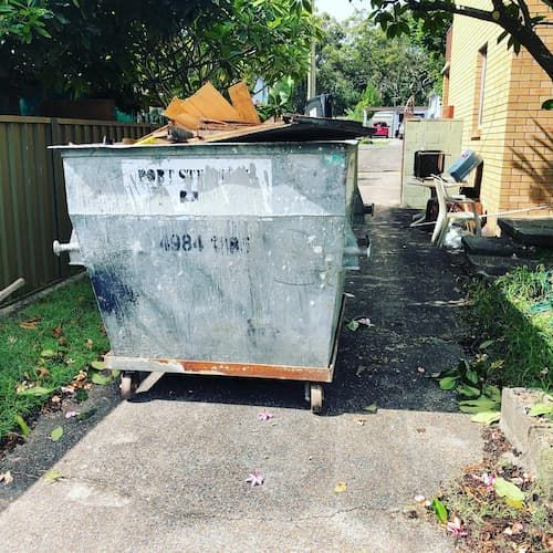 Scratched Waste Bin Filled with Rubbish - Skip Hire in Port Stephens