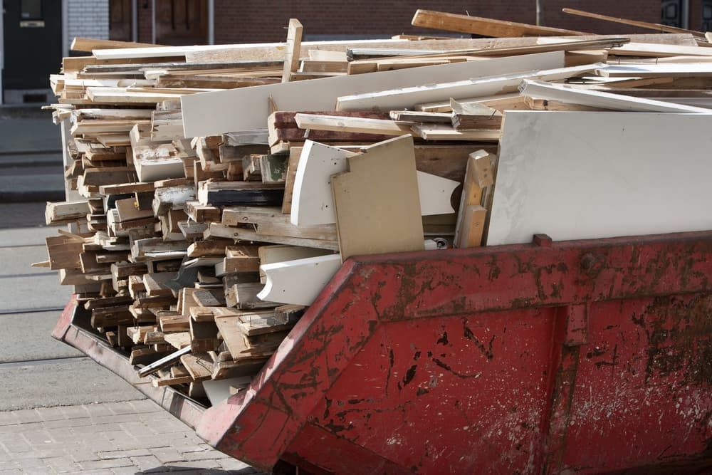 Red Skip With Pile Of Old Wood - Skip Bin Hire in Medowie, NSW