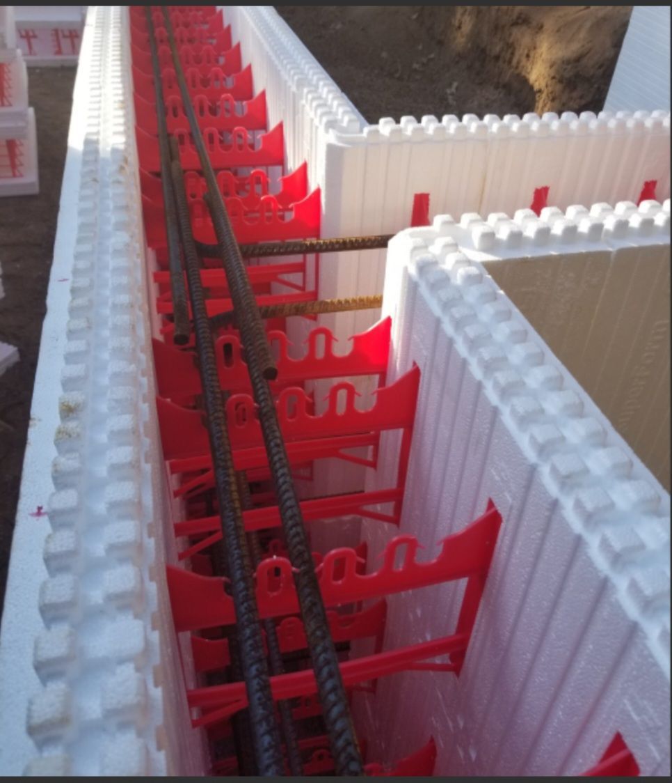 Steel reinforcing bars in a concrete form, showing construction detail.