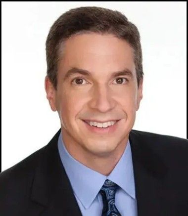 Man in a suit smiling, looking at the camera. Brown hair and eyes, light skin. Man in a suit smiling, looking at the camera. Brown hair and eyes, light skin.