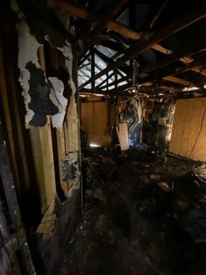 Charred wall studs and burned framing inside a fire damaged Orlando FL home