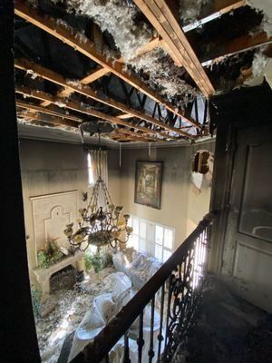 Burned ceiling and exposed joists in the great room of a fire damaged Orlando home
