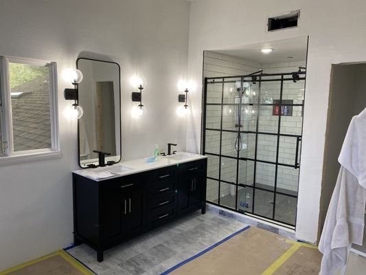 Rebuilt bathroom with new tile and glass shower during fire damage reconstruction in Orlando