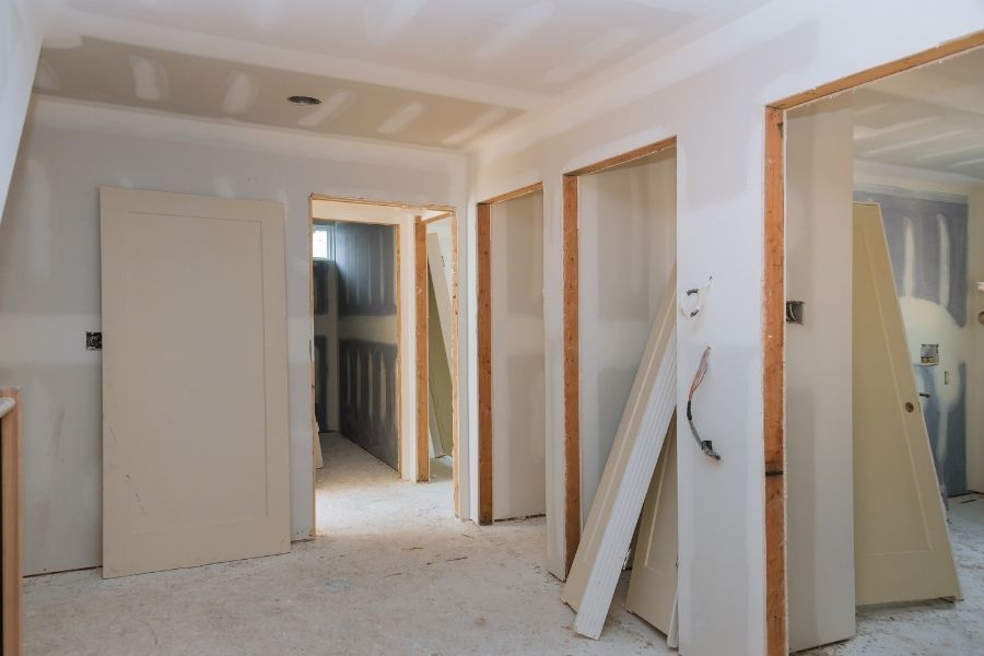 Home interior mid-reconstruction with newly hung drywall and unfinished framing in a Tavares FL rebuild