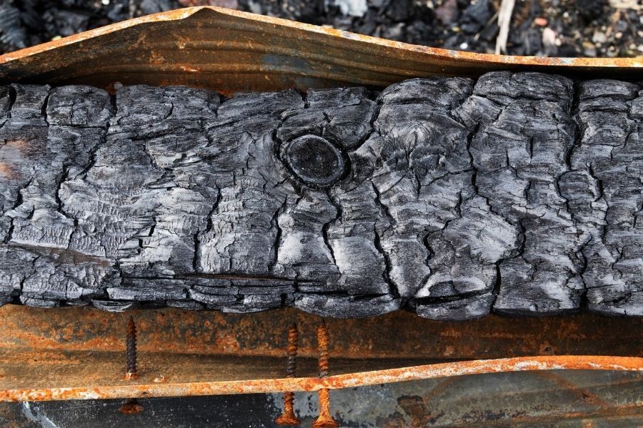 Charred wall studs exposed after burned drywall was removed during structural fire damage restoration in a Central Florida home