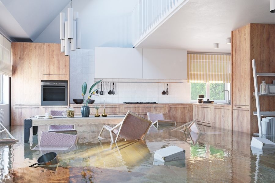 Flooded kitchen with floating furniture from a burst refrigerator water line