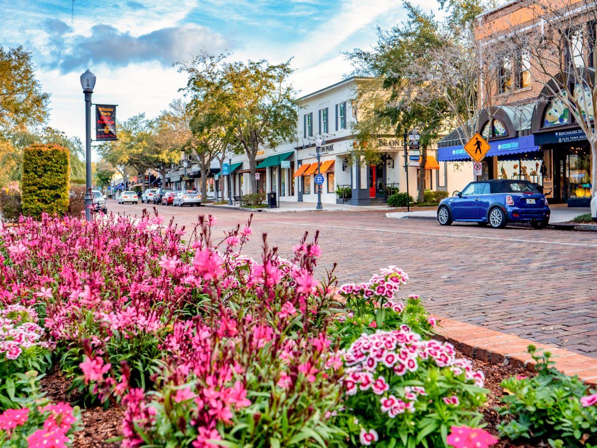 picture of a road in winter park, fl with buildings and flowers