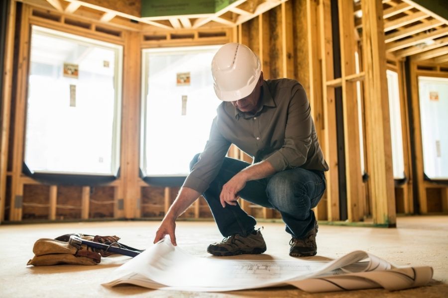 Contractor reviewing reconstruction plans