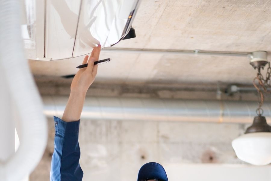 HVAC maintenance being performed on residential air conditioning unit