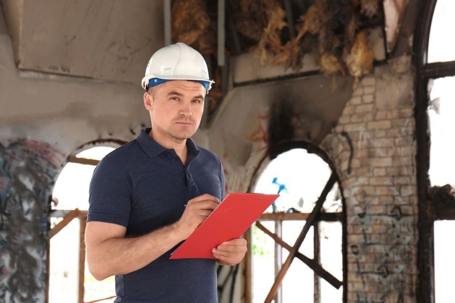 Insurance adjuster reviewing property damage documentation