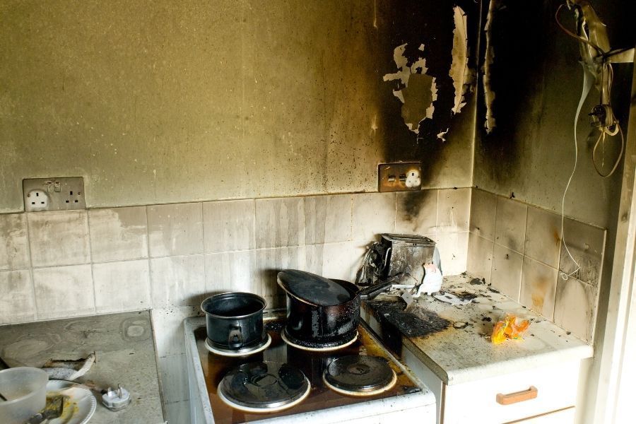 Kitchen showing fire and soot damage requiring cleanup