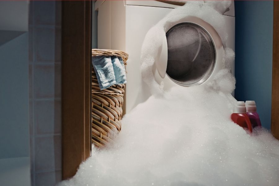 Foam and water overflowing from washing machine
