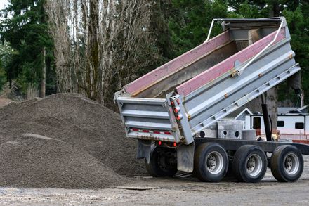 Delivery truck unloading material