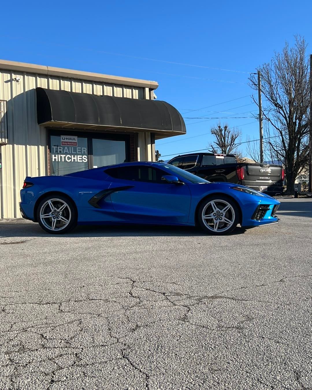 Blue sports car parked outside a building with a
