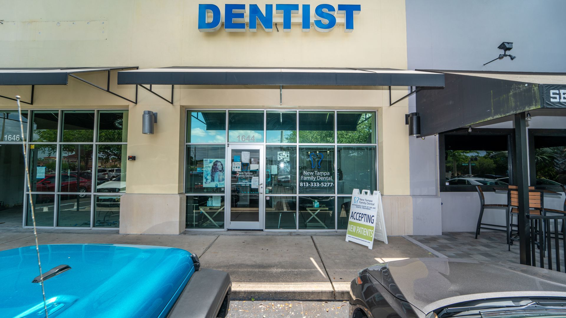 A car is parked in front of a dentist 's office.
