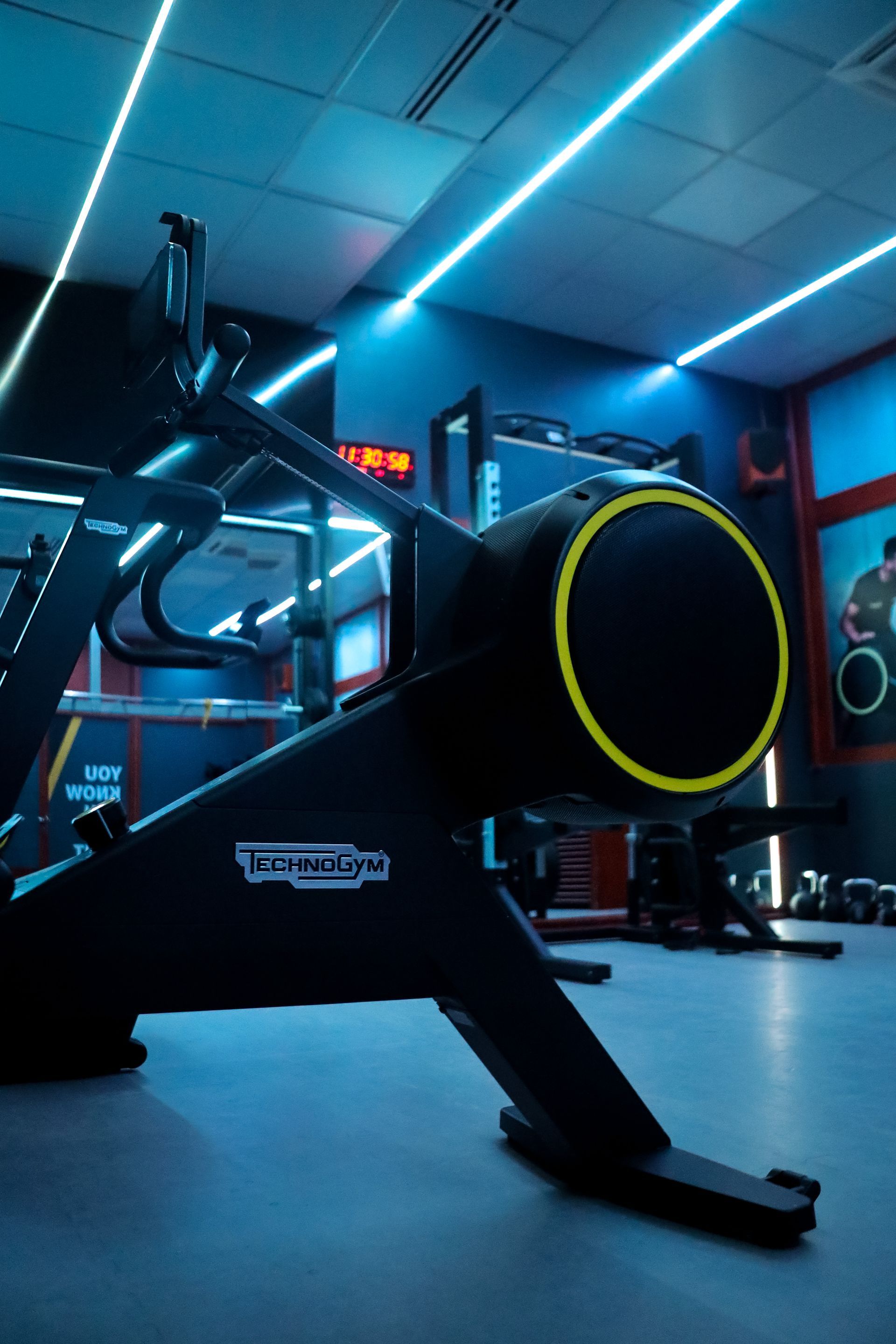 a treadmill is sitting on the floor in a gym .