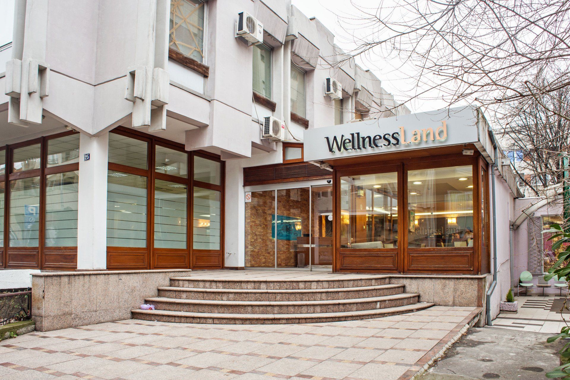 a large white building with stairs leading up to the entrance .