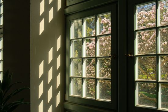 The sun is shining through the windows of a building.