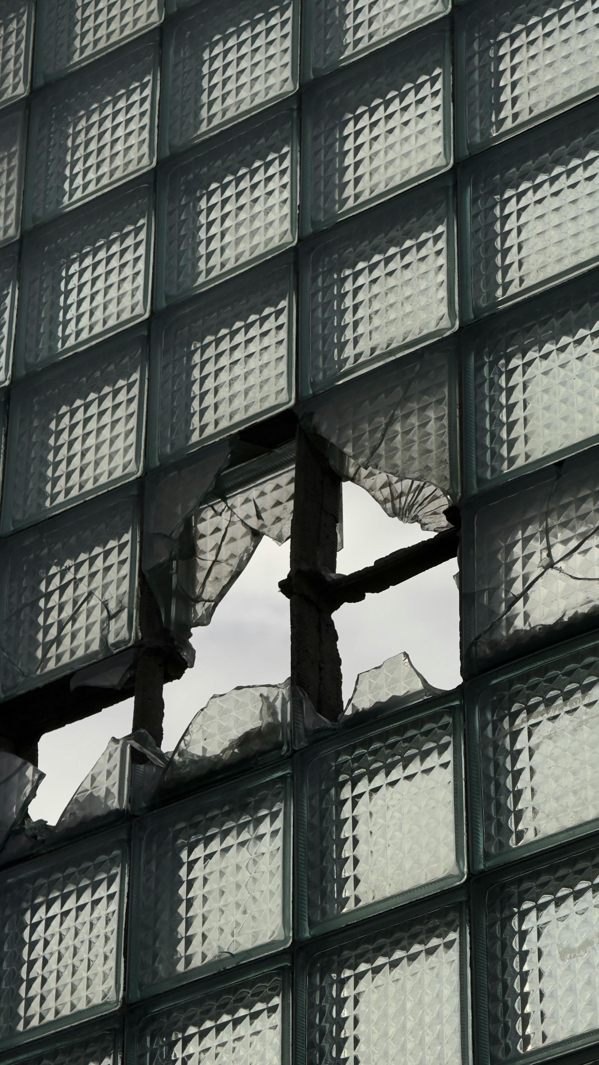 Broken window with shattered glass panes showing damage requiring window replacement in Oklahoma