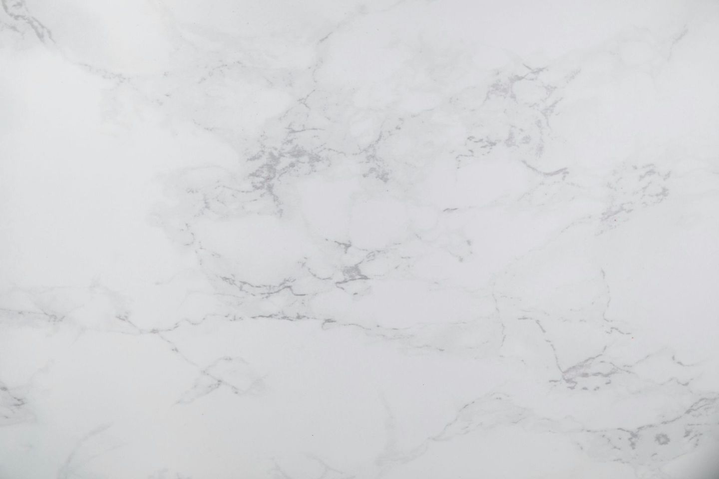 A close up of a white marble counter top.