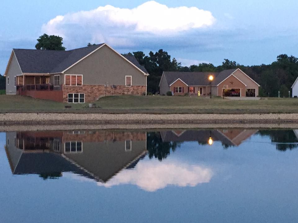 Two lakeside houses with garages. 