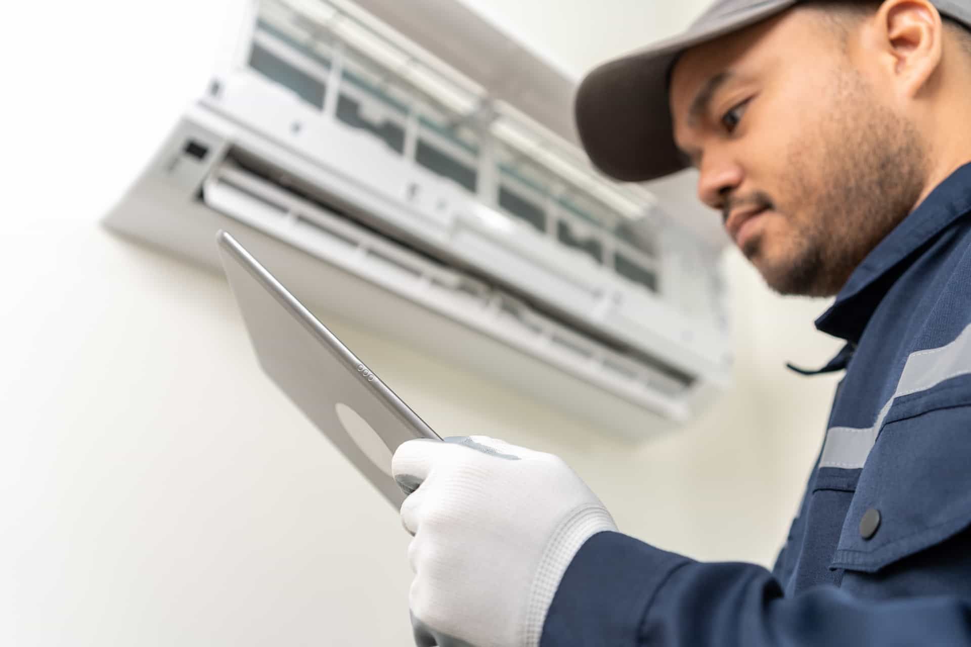 Technician performing routine HVAC maintenance