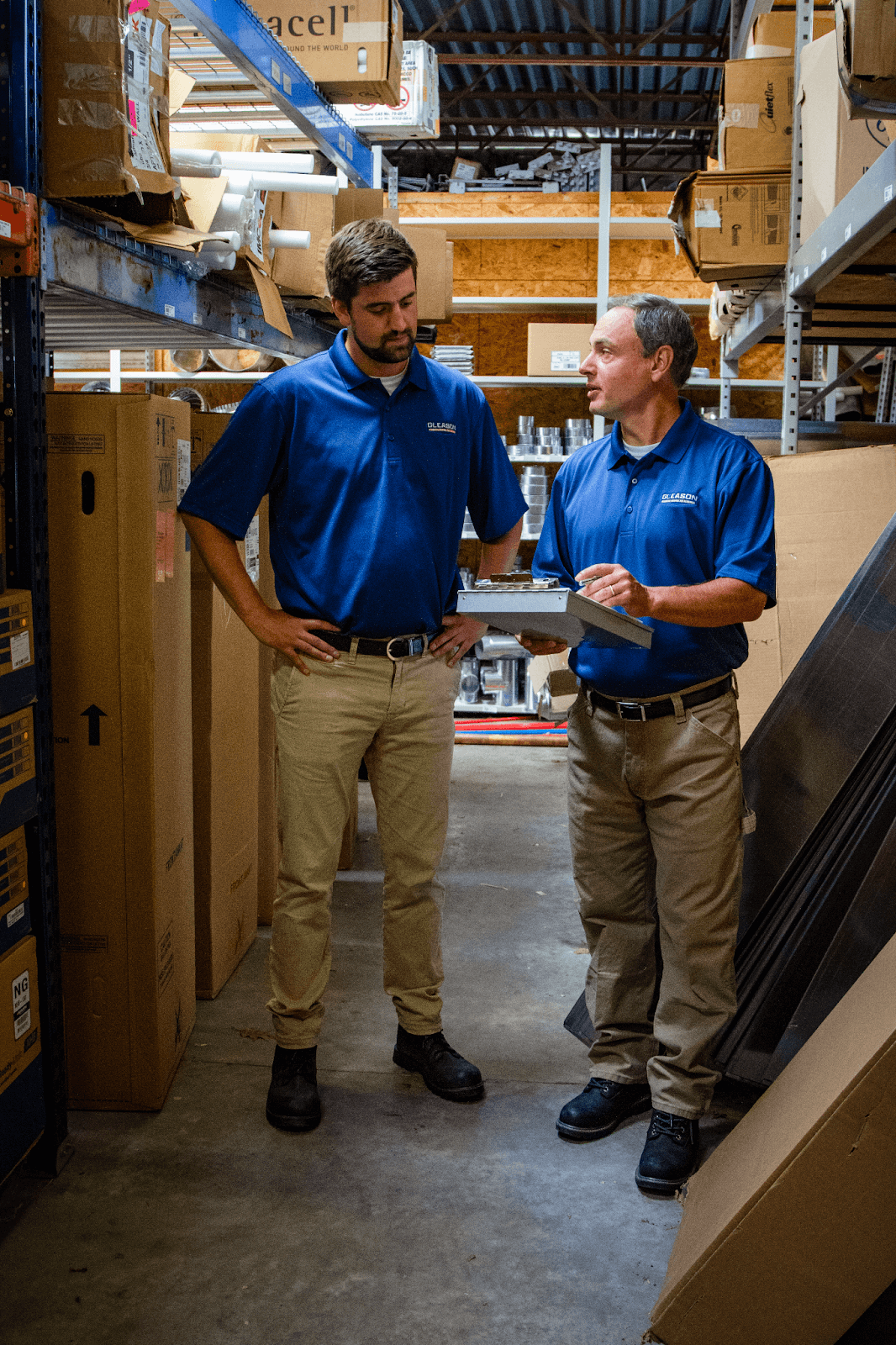 Two men are standing and discussing Commercial Heating Repairs
