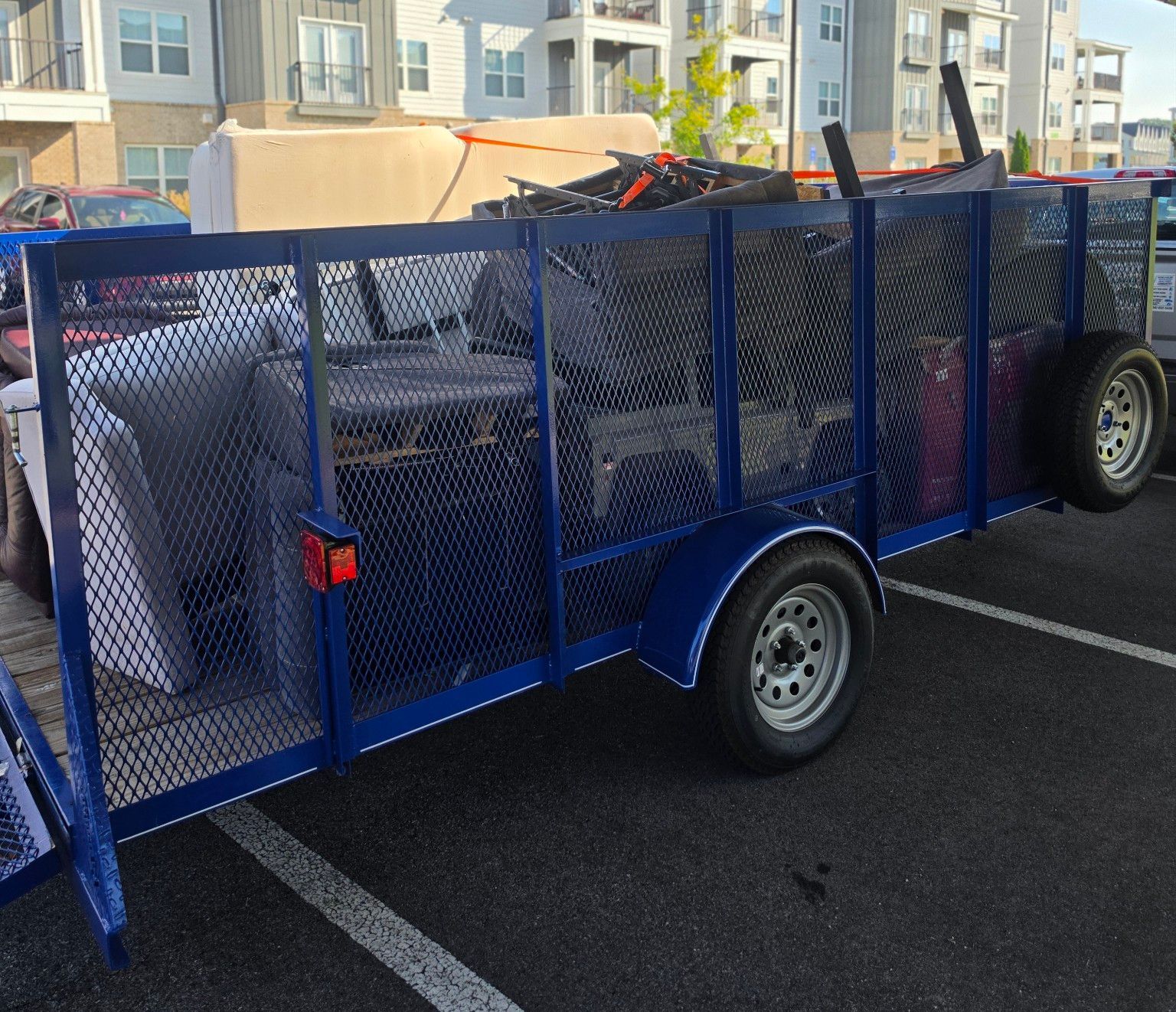 Loaded junk removal trailer at an apartment community in North Alabama