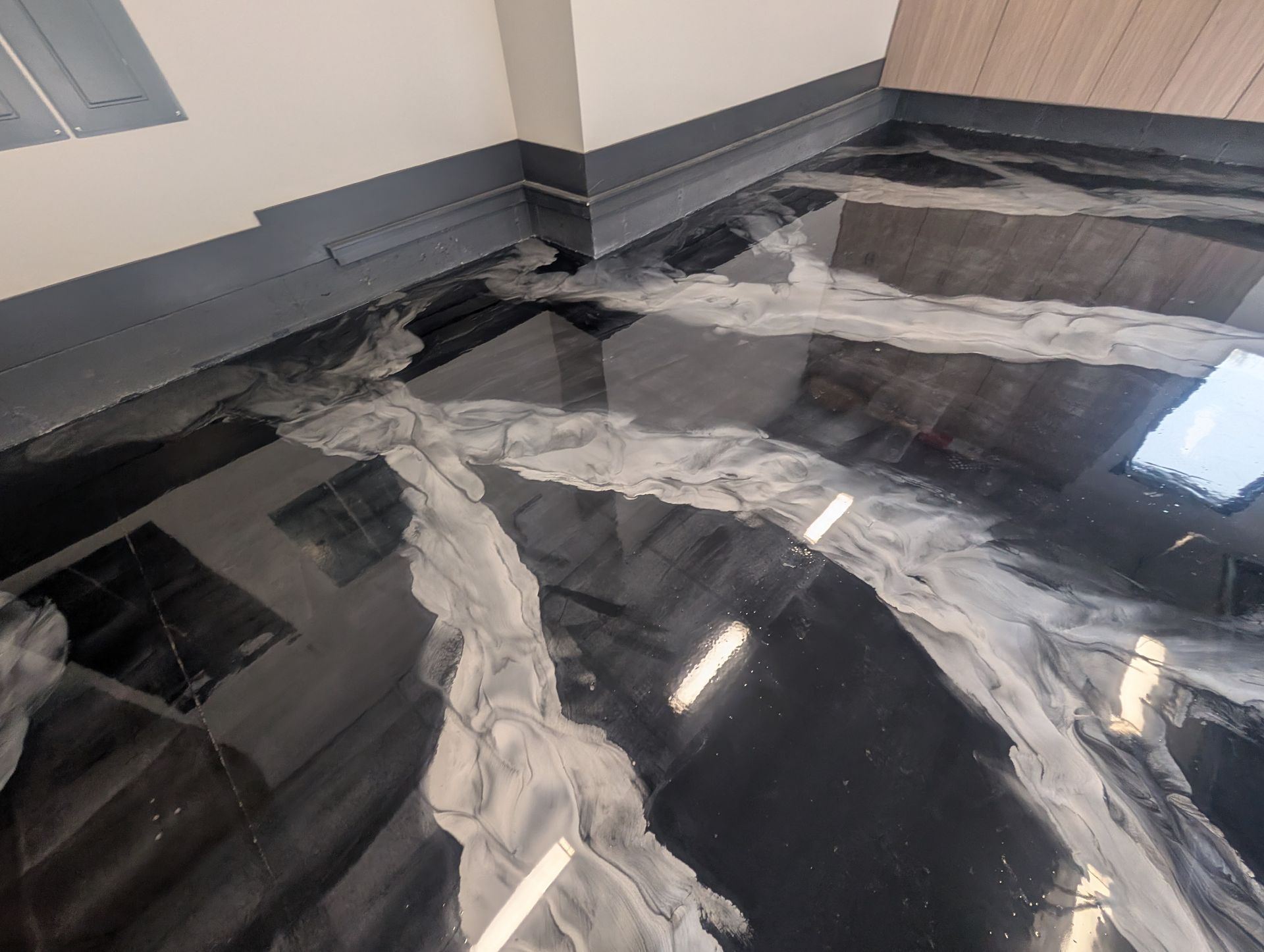 High-end metallic epoxy basement floor with gold and bronze swirls