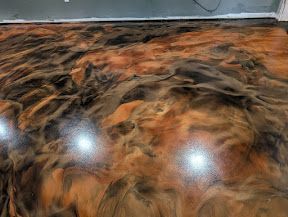 A luxury interior with a shimmering metallic epoxy floor featuring deep blue and silver swirls.
