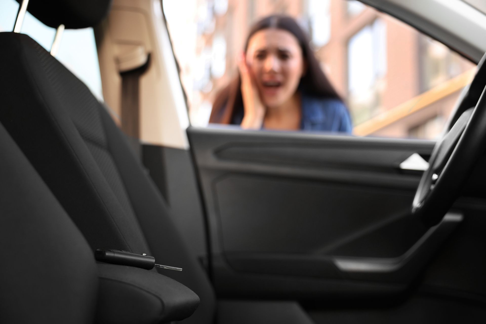 Person unlocking car door with lock picks.