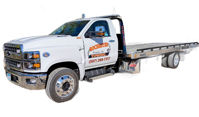 White tow truck with flatbed, company logo on the door.