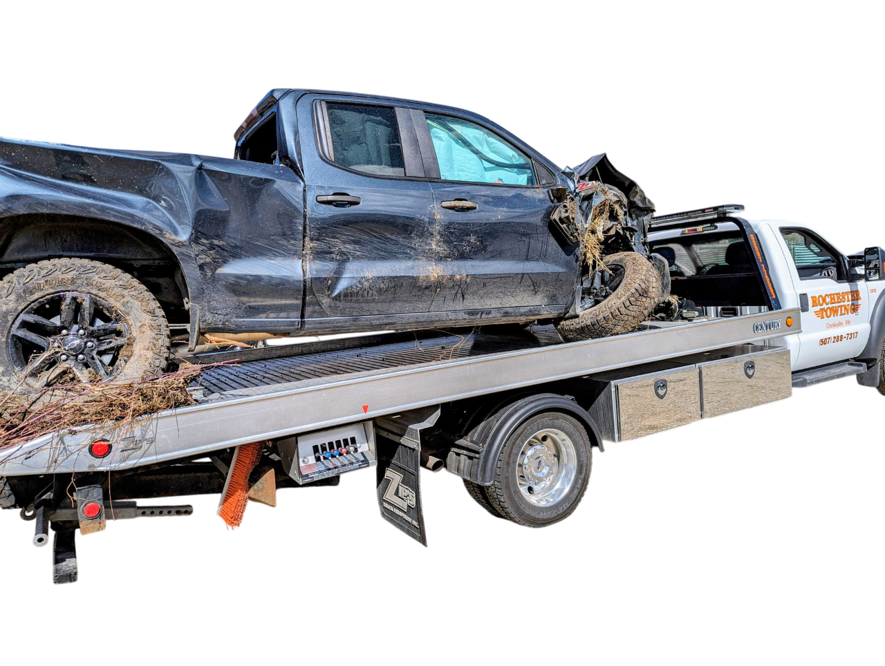 A yellow tow truck with a wrecked dark grey car on its flatbed.