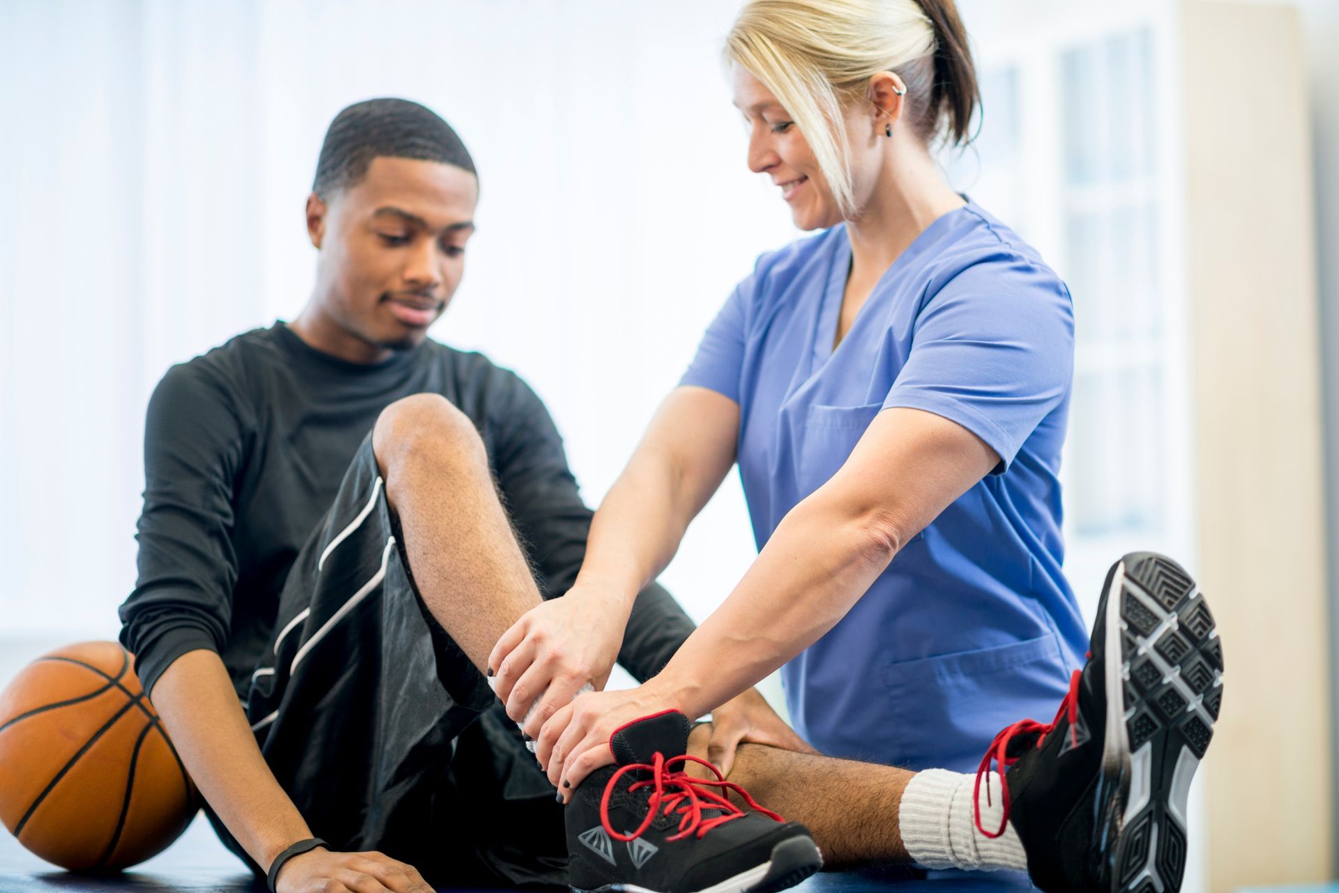 Basketball Player Getting Physical Therapy — Burien, WA — Southwest Seattle Physical Therapy & Sports Rehabilitation Basketball Player Getting Physical Therapy — Burien, WA — Southwest Seattle Physical Therapy & Sports Rehabilitation