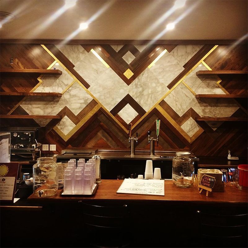 A bar with a geometric design on the wall