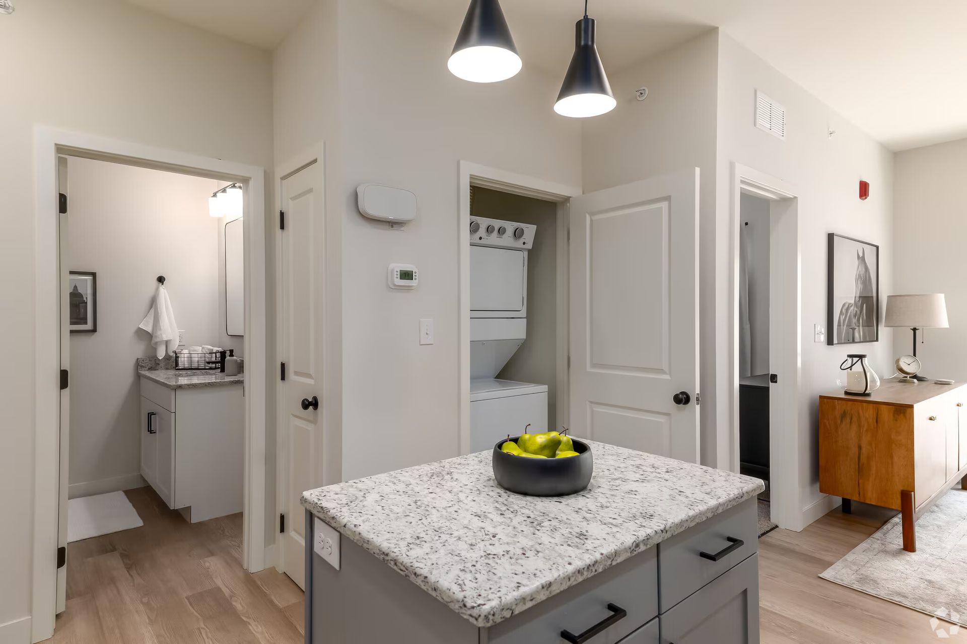 Photo of an area in the kitchen, with a bathroom in the background