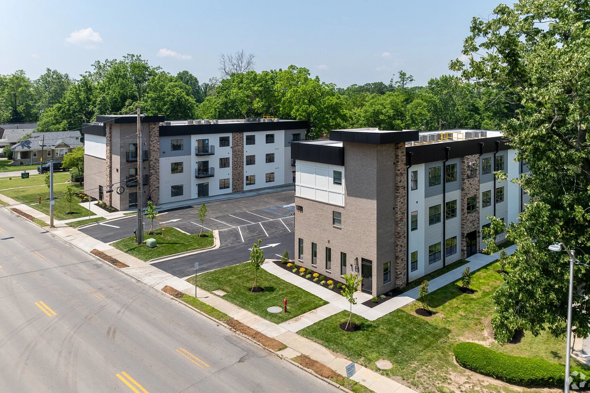 Photo of a set of buildings, with a parking lot between them