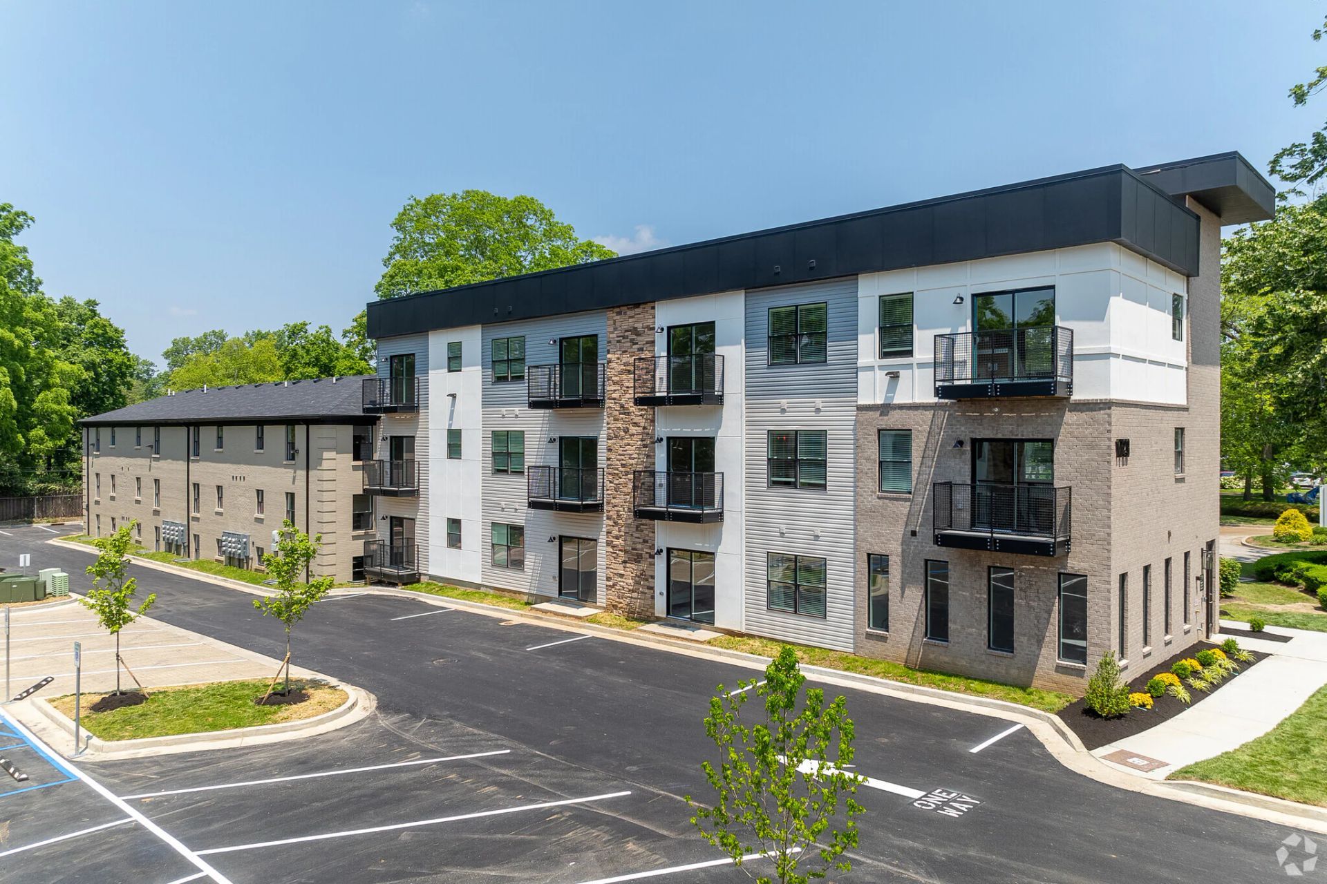 Photo of a building showing multiple stories and a parking lot