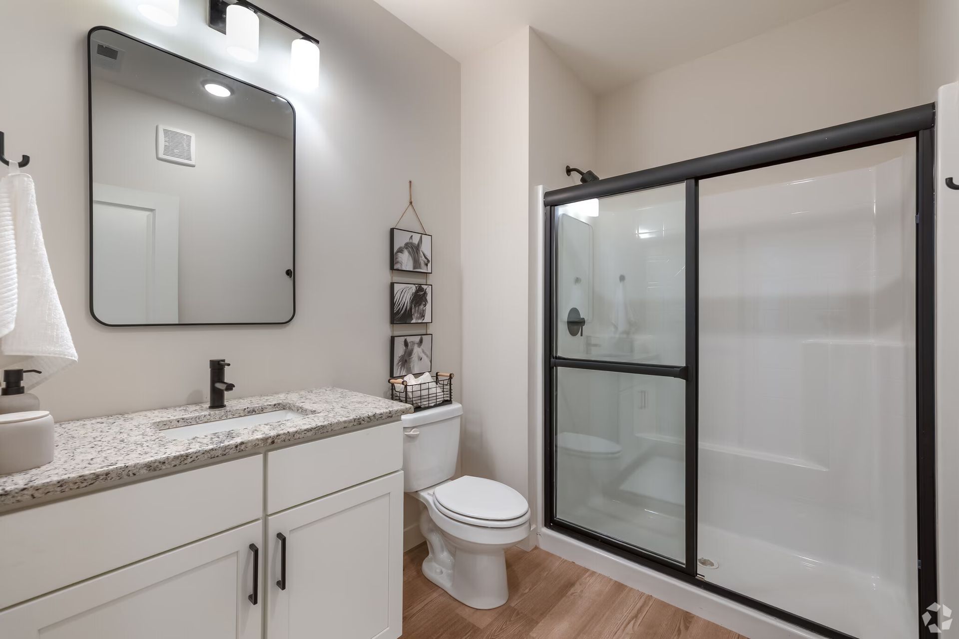 Photo of a bathroom, showing the sink, toilet and shower