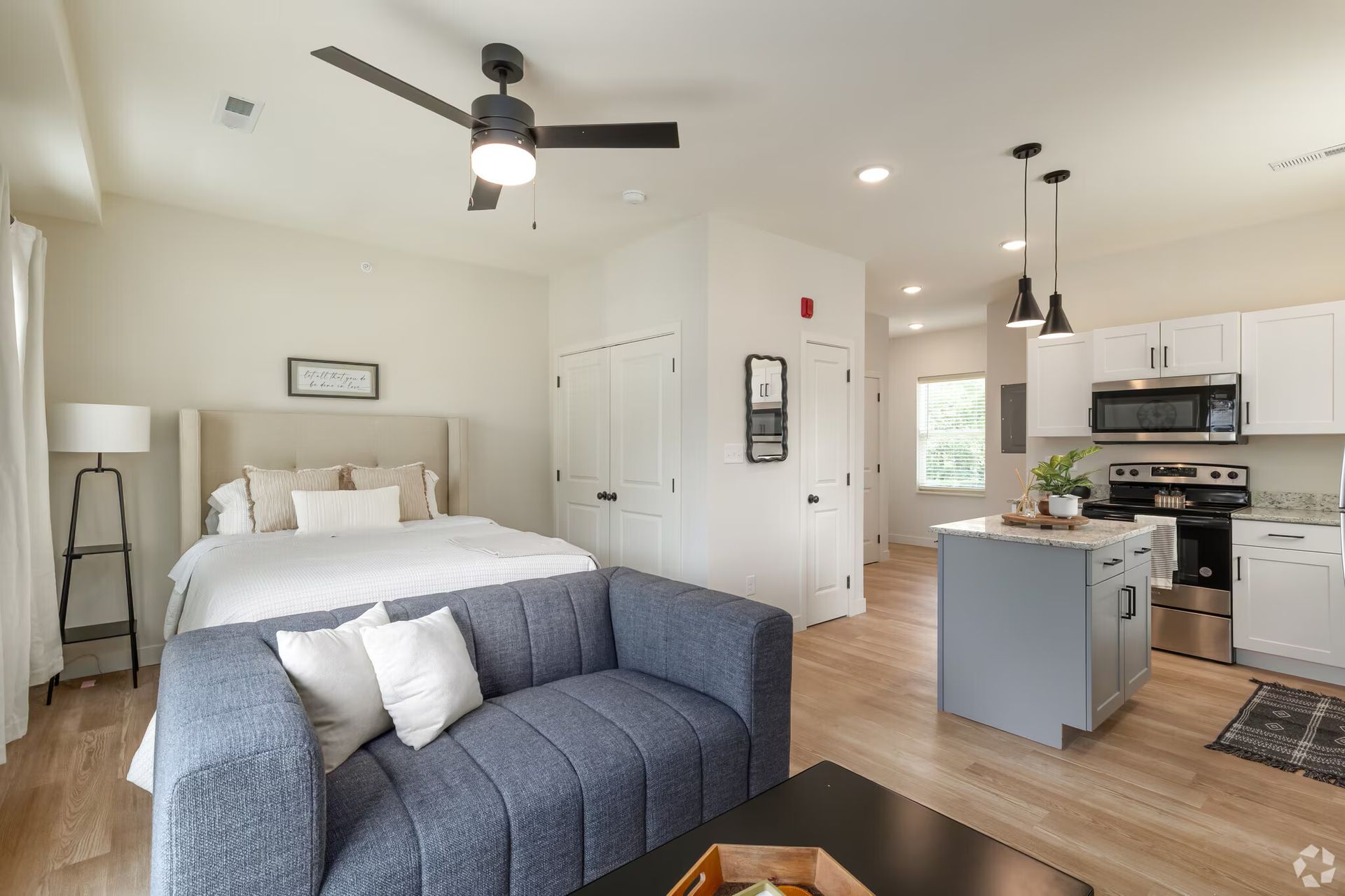 Photo of a studio, showing a sleeping area, couch, and kitchen
