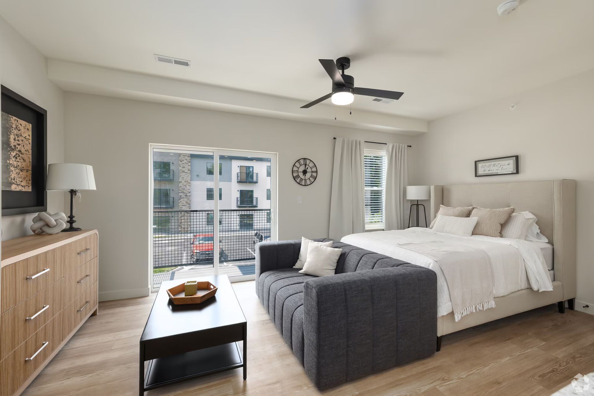 Photo of a studio showing the sleeping area, couch, and a balcony