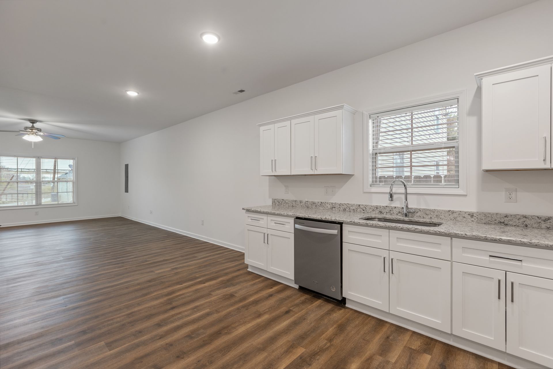 Photo of a large living room that seamlessly integrates into the kitchen