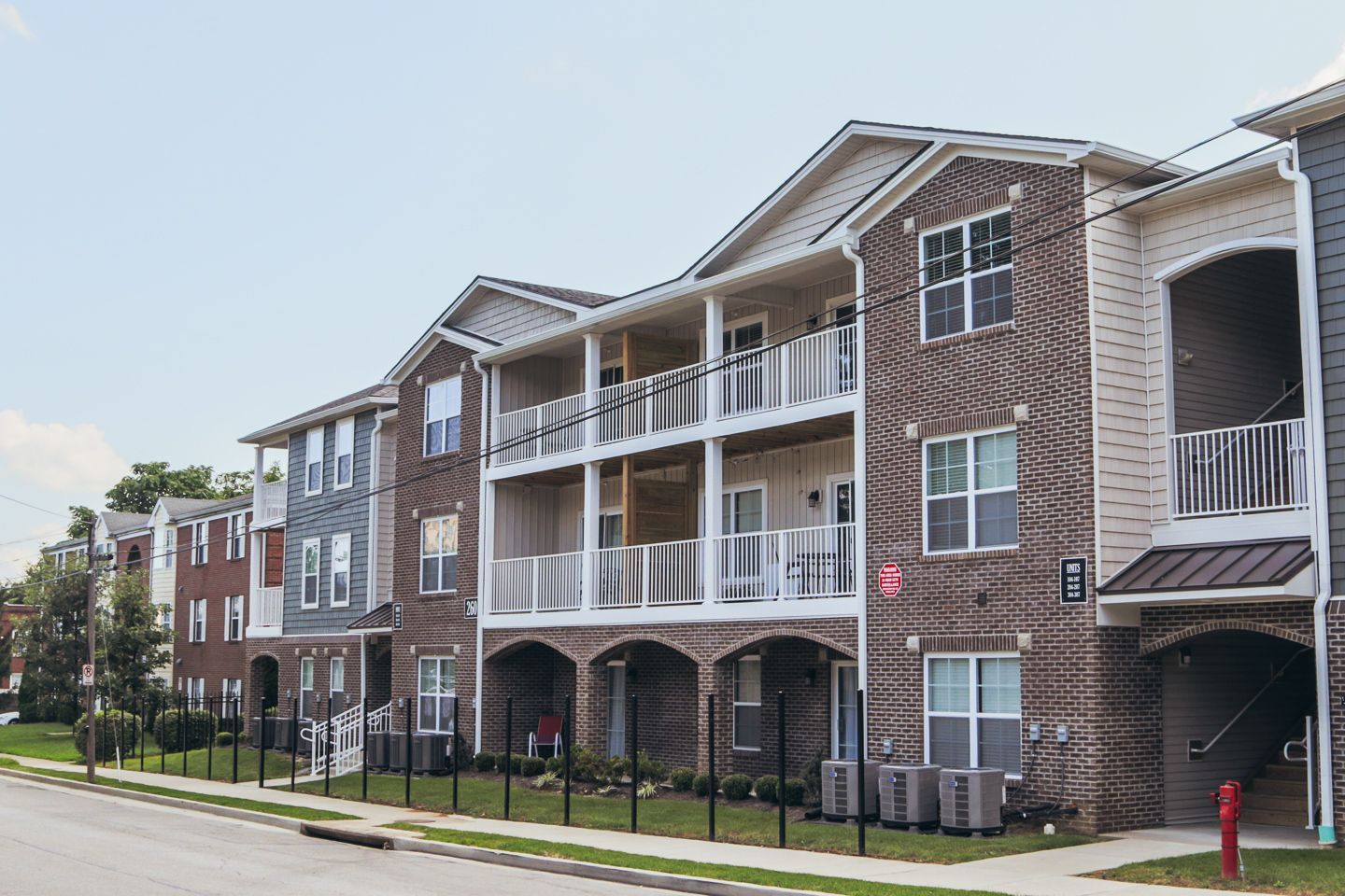 Photo of a large, three story building with multiple vaulted entrances
