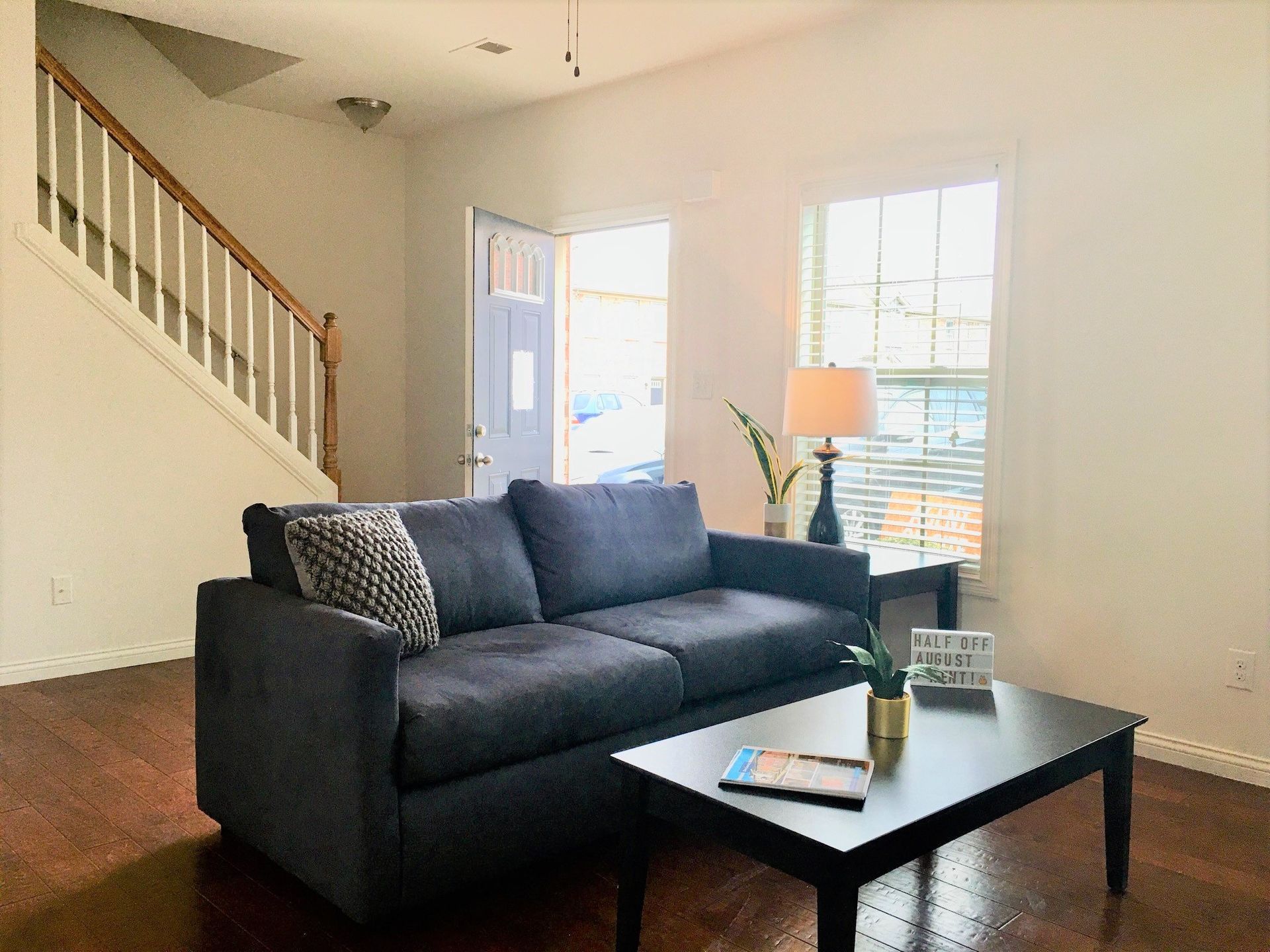 Photo of a living room with a set of stairs in the background