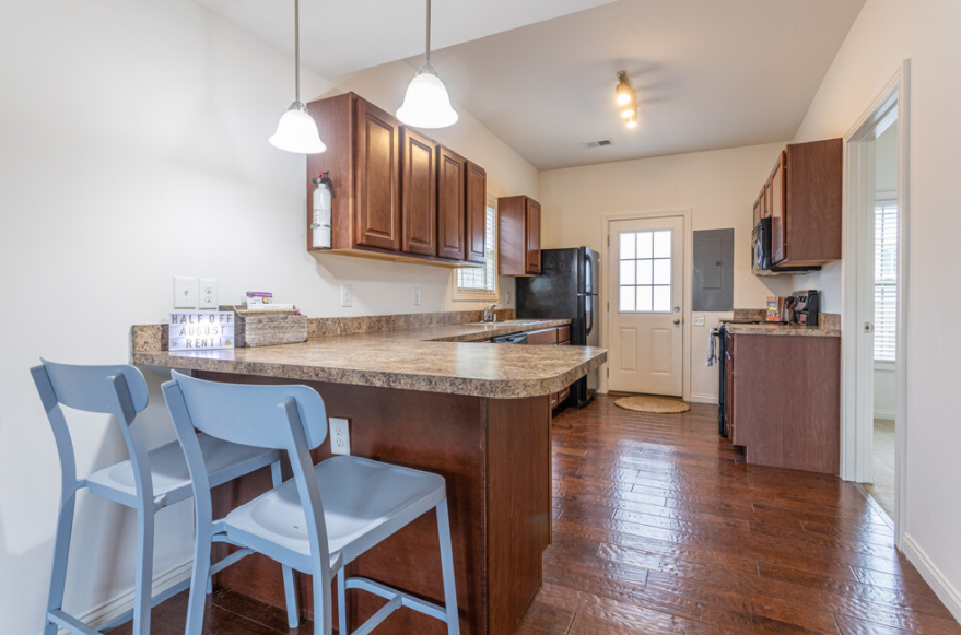 Photo of a kitchen with a barstool area