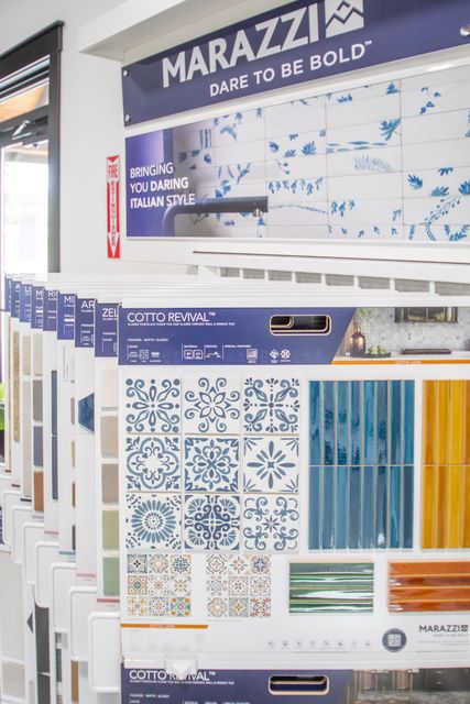 Tile display with various patterns and colors under a Marazzi sign.