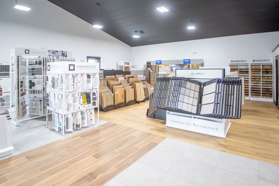 Flooring showroom with wood and tile samples on display.