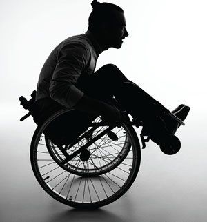 a silhouette of a man in a wheelchair