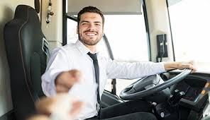 a man is sitting in the driver 's seat of a bus holding a ticket .